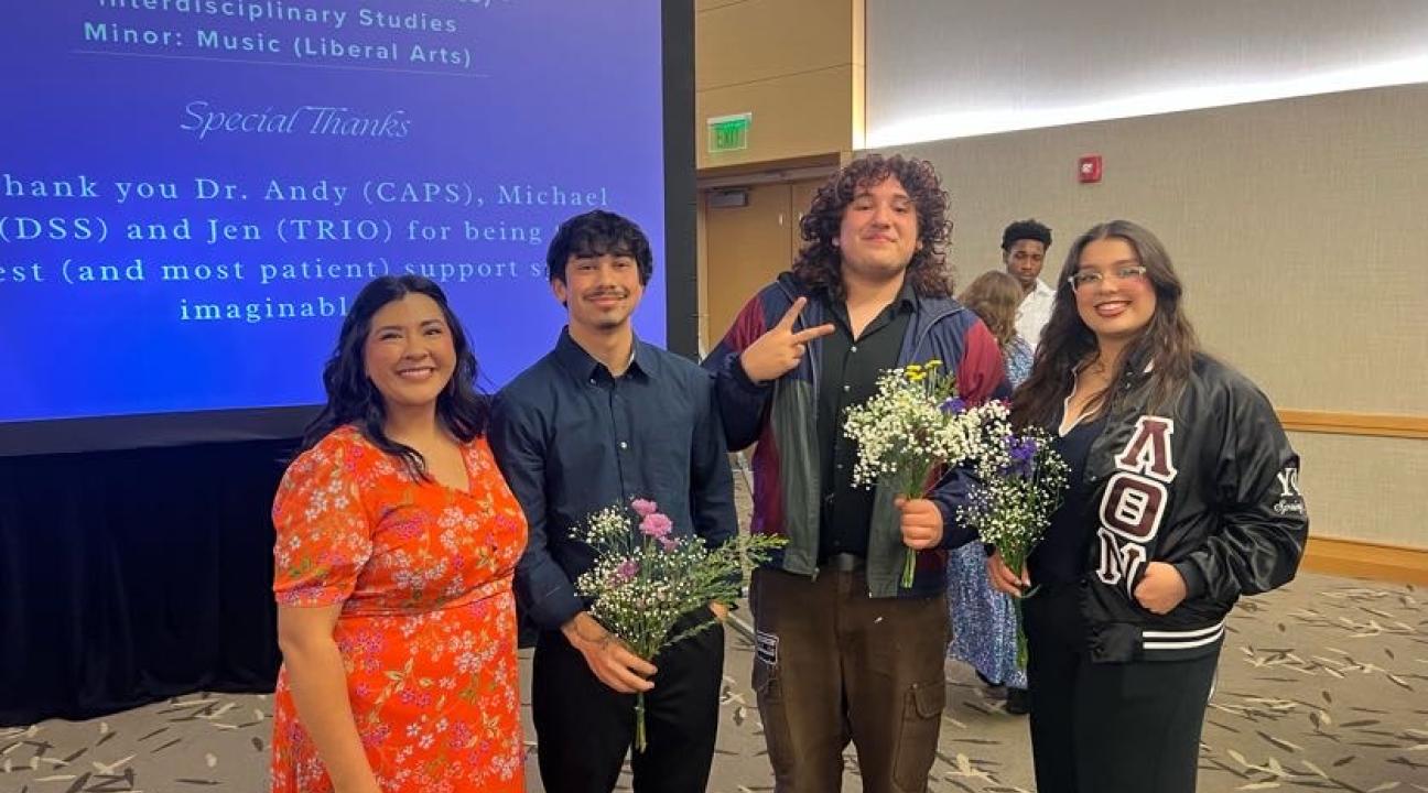 group of people smiling with flower in their hands