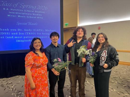 group of people smiling with flower in their hands