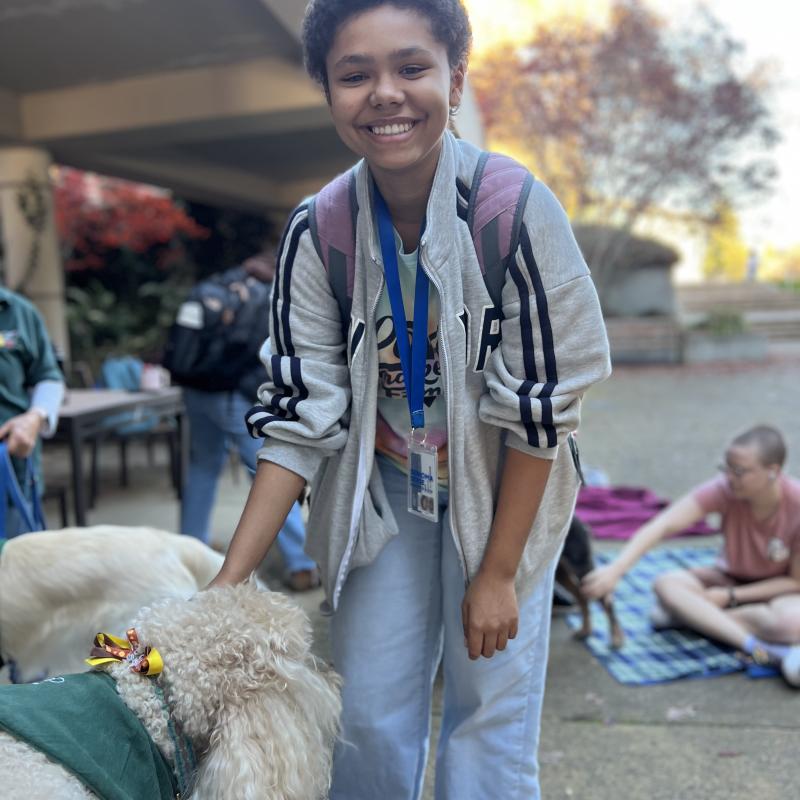 Seawolf Scholar student petting dog