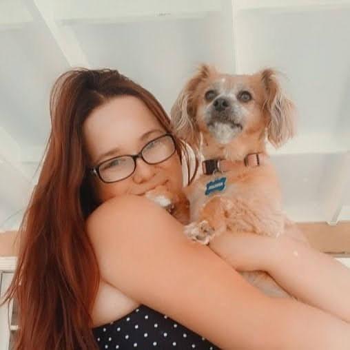 Bella Davidson holding small dog